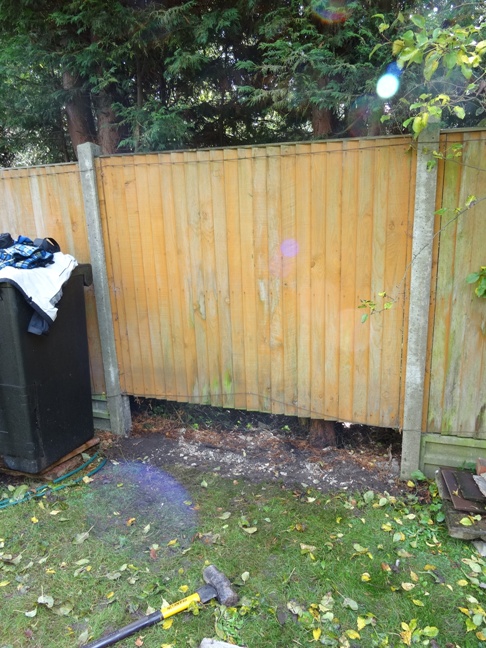 Remove the gravel board - the fence panel should remain in place