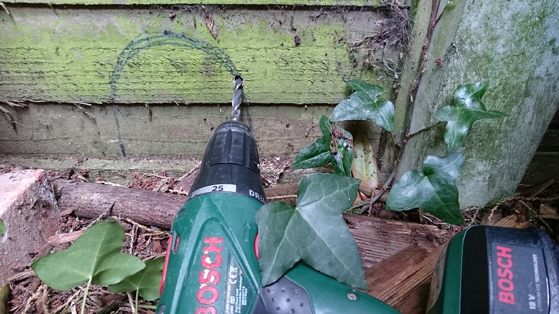 David Orme demonstrating how to cut a hole in a wooden fence panel